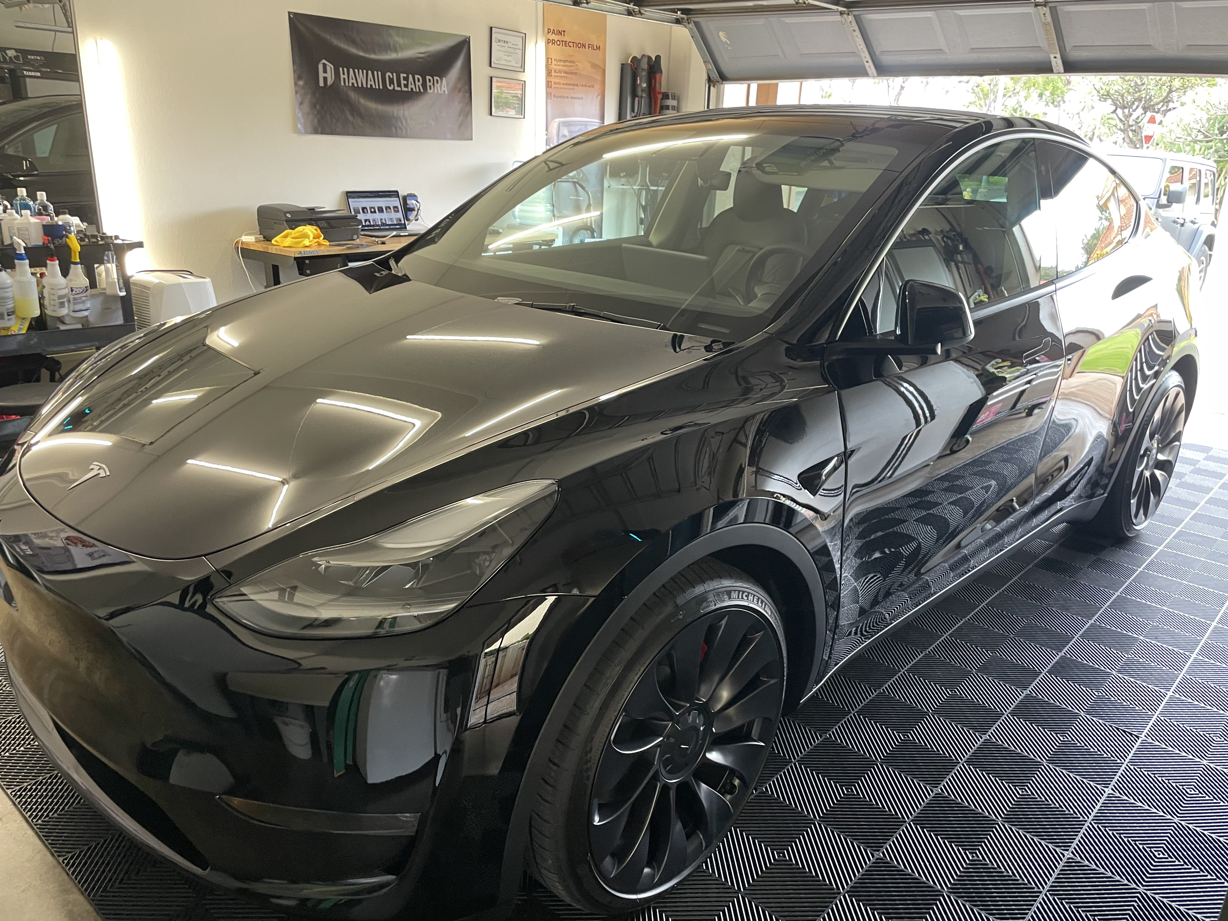 Tesla Model Y with Liquid PPF coating on blue epoxy floor