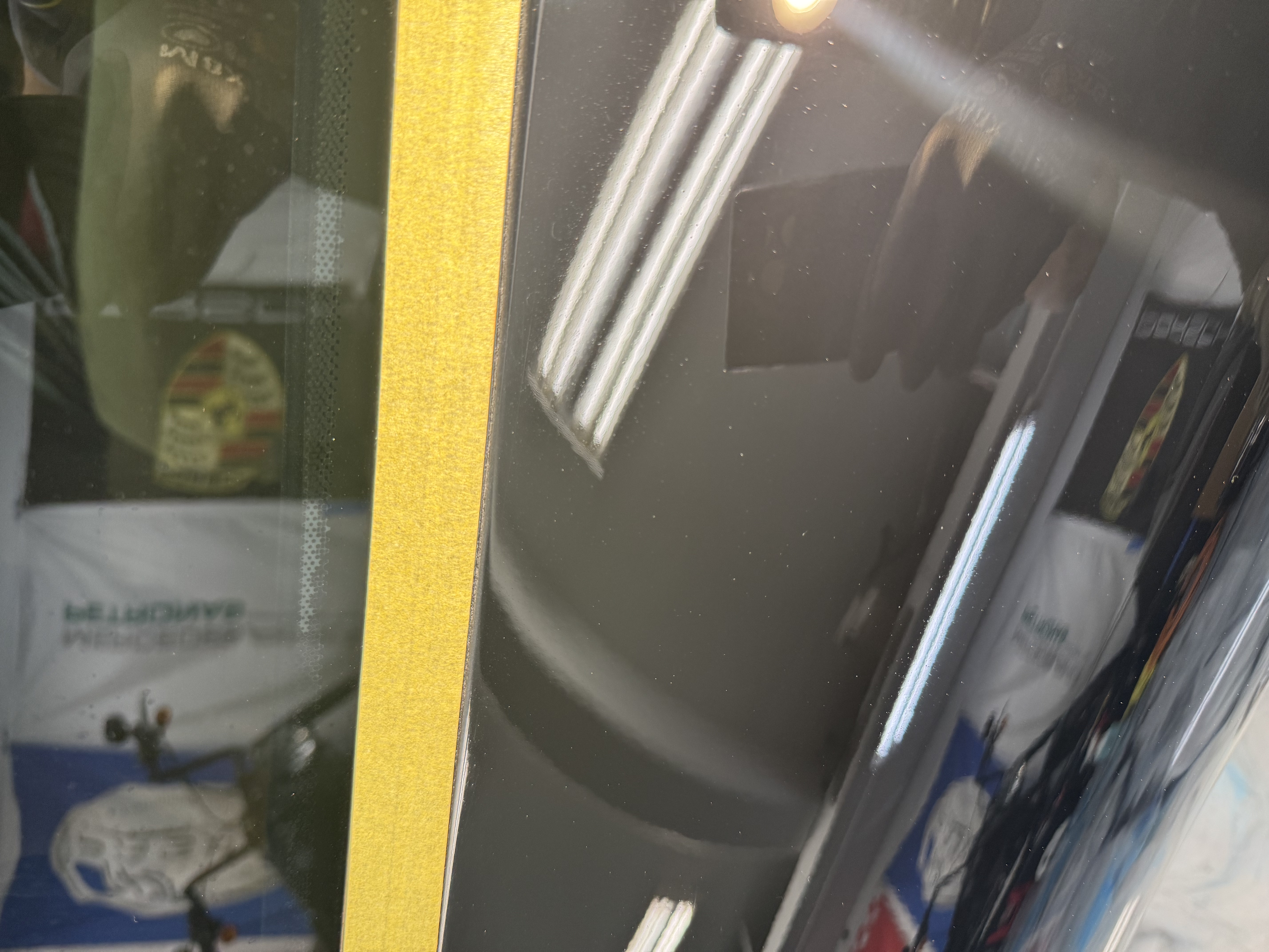 2002 Porsche 911 panel after two-stage paint correction — deep black gloss
