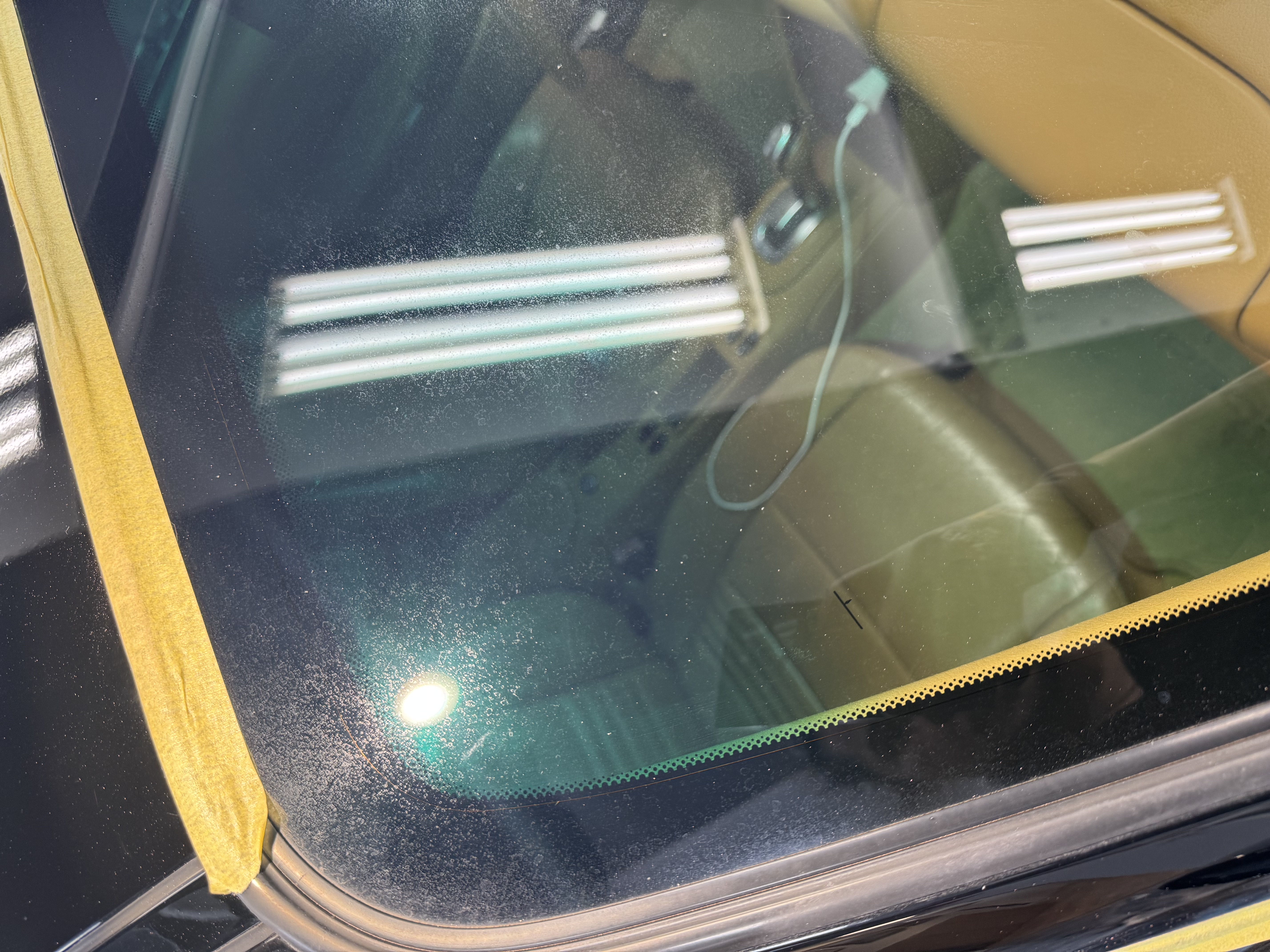 Porsche 911 windshield before — heavy water spot buildup