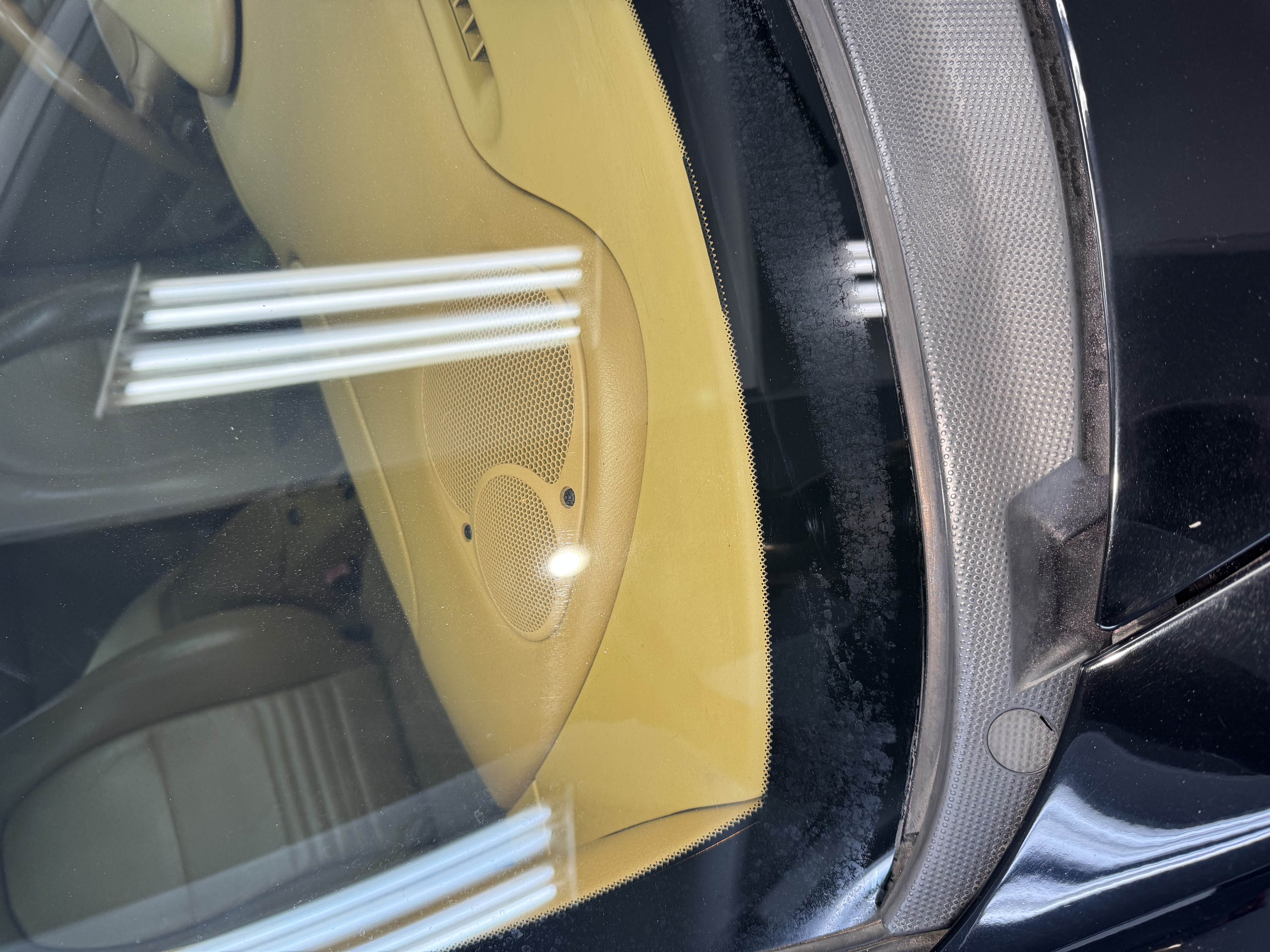 Porsche 911 side glass before — water spot haze