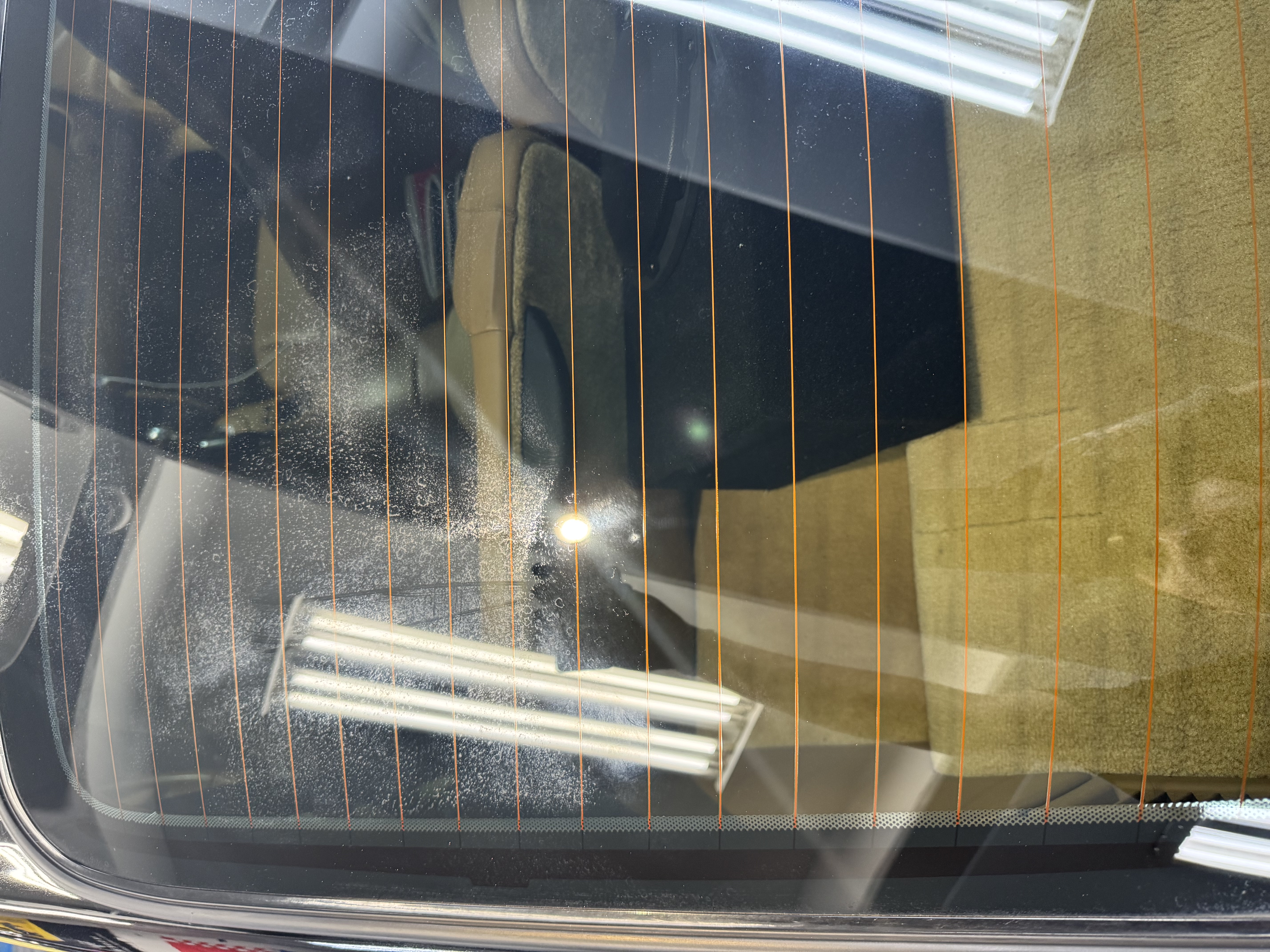 Porsche 911 rear glass before — mineral deposits and haze